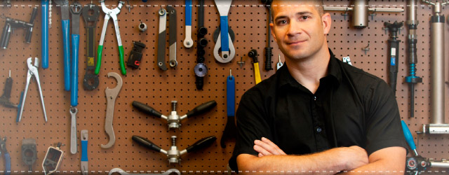 Man standing in front of tool wall