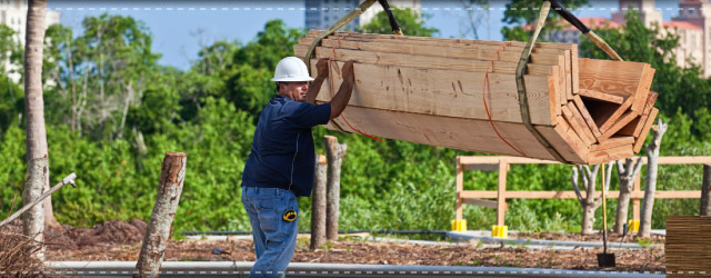 Crane lifting wood planks